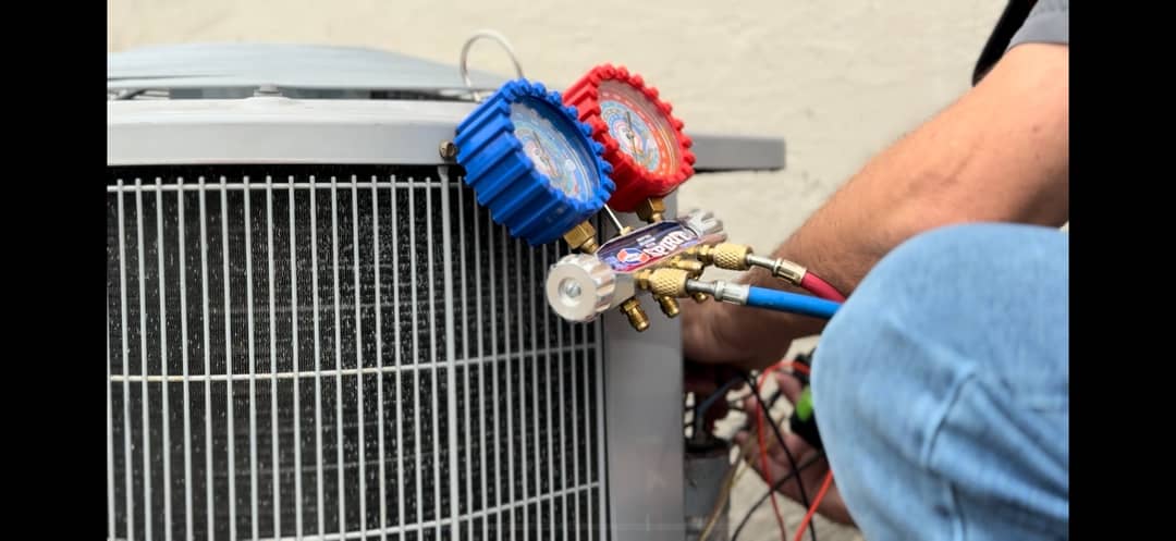 HVAC technician checking refrigerant levels during AC repair in League City TX