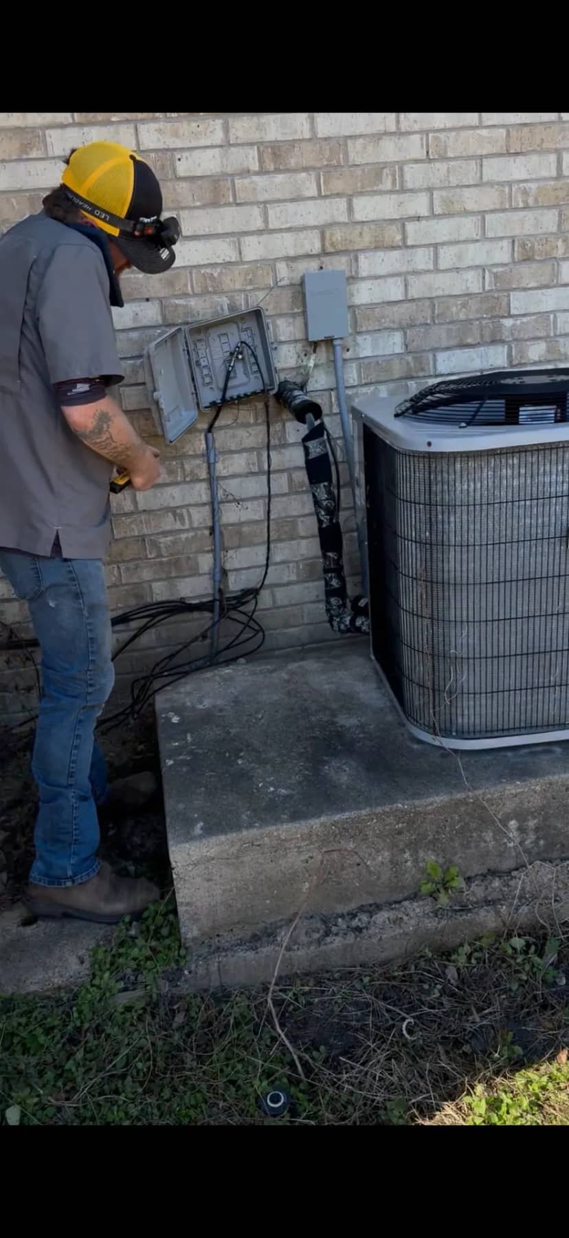 On The Way HVAC technician repairing outdoor AC unit in League City TX